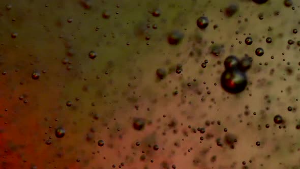 bubbles blowing up into a tough substance with a colored background