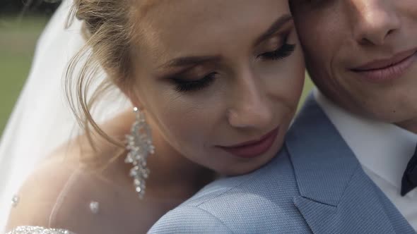 Newlyweds. Caucasian Groom with Bride in the Park. Wedding Couple. Happy Family