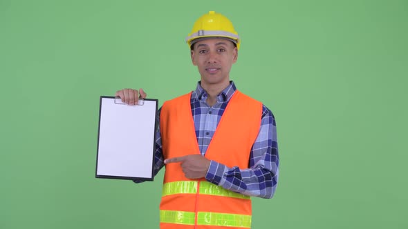 Happy Multi Ethnic Man Construction Worker Showing Clipboard and Giving Thumbs Up