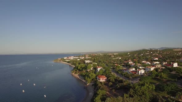  - Coastal Town Scene with Blue Sea. Aerial View of Trikorfo Beach, Greece