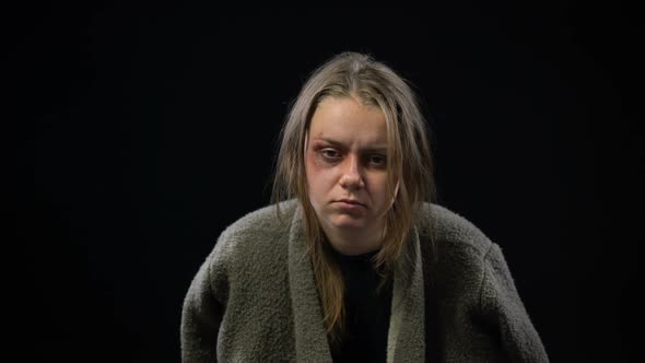 Depressed Female Hostage With Bruises on Face Looking to Camera, War Victim