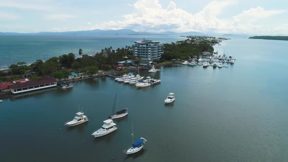 The highway separating the calm river and the sea in Puntarenas, Costa Rica. Aerial drone shot aroun