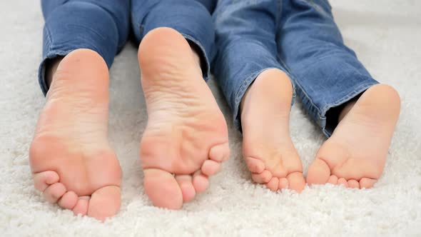CLoseup of Parent and Child Moving on Floor at Home and Moving Bare Feet
