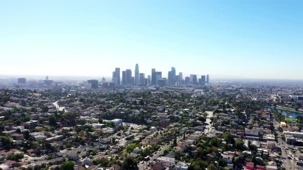 Beautiful drone shot flying over Los Angeles, California towards the downtown LA city skyline on a g