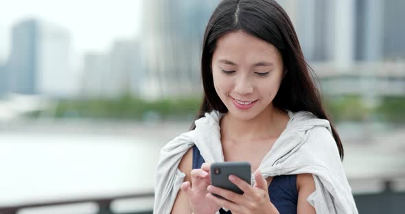 Woman use of mobile phone in city