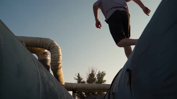 Happy man runs and jumps in the sunlight. Freedom and happiness. Bottom view. Slow motion