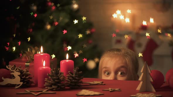 Girl Looking Out Table Decorated for Christmas Celebration, Festive Atmosphere