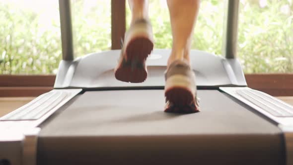 Legs Fitness Training In Gym. Treadmill Marathon Runner Jogging. Cardio Run Workout On Treadmill