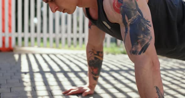 Portrait of Male Athlete Doing Exercises Outdoors in Summer