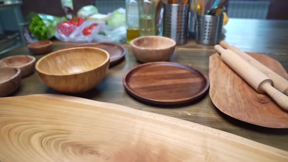 Kitchen Table with Wooden Utensils Boards Rolling Pins and Cutlery Stands