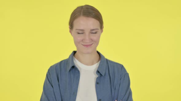 Young Woman Shaking Head As Yes Sign on Yellow Background