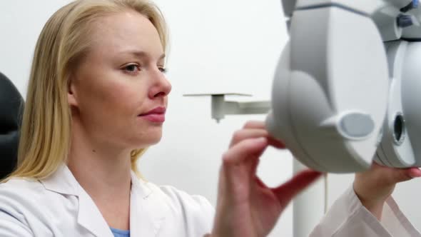 Female optometrist adjusting chiropter