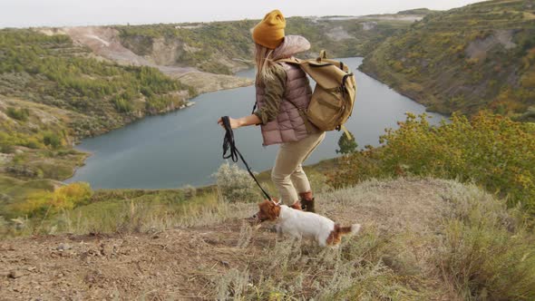 Woman with Cute Dog Hiking in Scenic Location