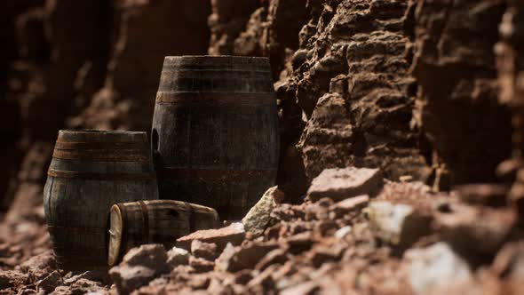 Old Wooden Vintage Wine Barrels Near Stone Wall in Canyon