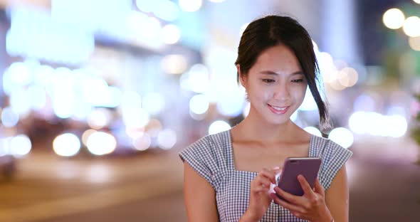 Woman look at cellphone at outdoor street
