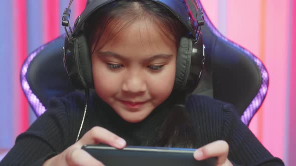 Close Up Challenge Gamer Girl Playing A Game Online On Smartphone While Sitting On The Chair At Home