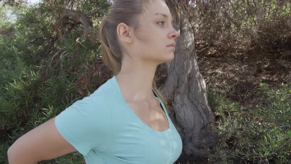 A young woman runner stretching before her run.