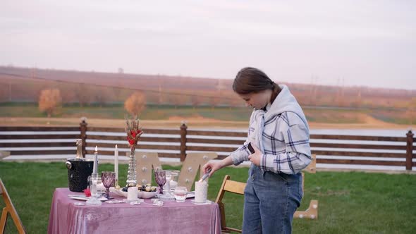 The Romantic Decor Prepared Outside Under the Background of a Rustic View