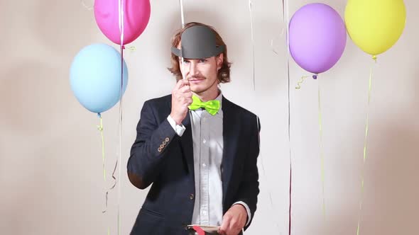 Young man changing props in photo booth