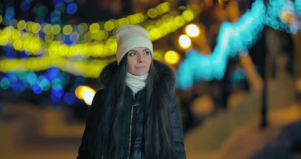 Beautiful Woman Walking Through the City at Night