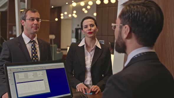 Business Visitors at Hotel Check-In