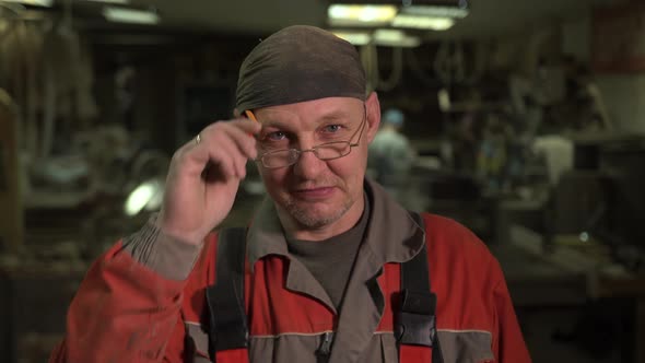 Portrait of Lumberjack on Wood Furniture Production Looking at Camera