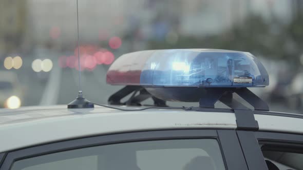 Flashing Flasher on the Roof of a Police Car. Blinker. Close-up.