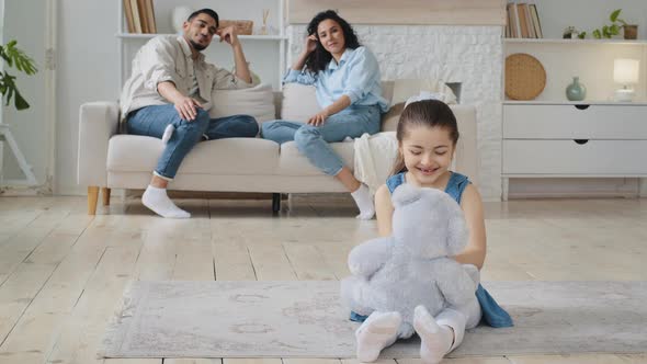 Caucasian Spaniard Little Daughter Girl Child Sitting Living Room Floor Playing with Teddy Bear