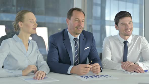 Ambitious Executive Business People Giving Presentation on Office Desk