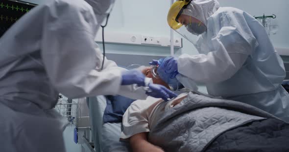 Doctors Pumping Oxygen Into Senior Patient