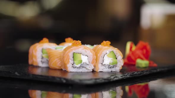 Taking Sushi Using Bamboo Sticks in a Japanese Restaurant