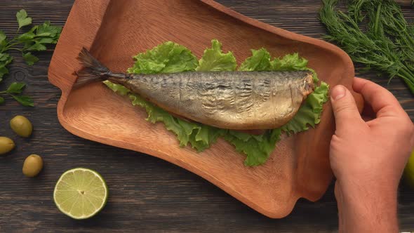 Top View of the Hand Putting a Wooden Plate with a Juicy Grilled Red Char Fish / Videohive