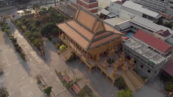 Majestic imposing hall of the Golden Temple of Phnom Penh in Cambodia - Aerial Orbit shot