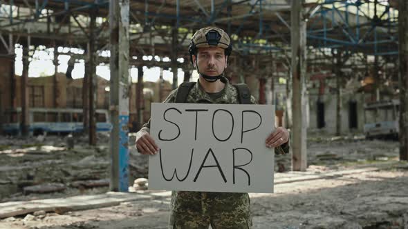 Professional Soldier Holding Stop War Billboard in Hands