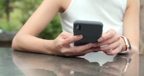 Woman use of smart phone at outdoor cafe