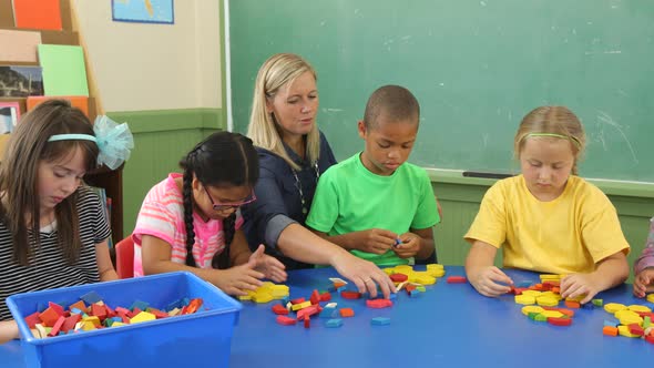 Students in school classroom experiment with shape blocks