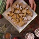 Hand Puts a Plate of Christmas Cookies on the Table - VideoHive Item for Sale