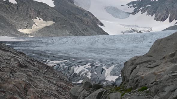 Rhone blue glacier on top of the Alps with rocky and snowy mountains aside, Switzerland, Valais