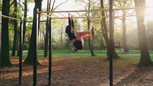 Sporty Woman Training Abdominal Muscles at City Park