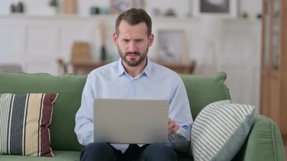 Angry Young Man Feeling Disappointed on Laptop 