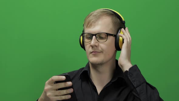 Guy Listens To Music in Wireless Yellow Headphones and Dances,Chroma Key