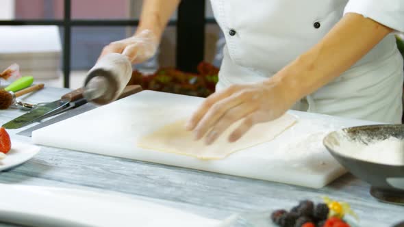 Male Hands Rolling Out Dough.