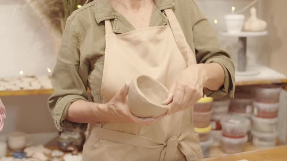 Unrecognizable Female Potter Sculpting Clay Bowl at Masterclass