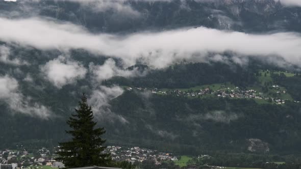 Panoramic View Liechtenstein with Houses on Green Hills in Cloudy Alps Mountain