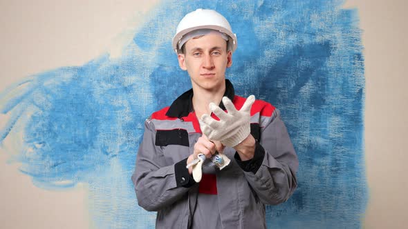 Inspired Construction Painter Puts on White Gloves in Room