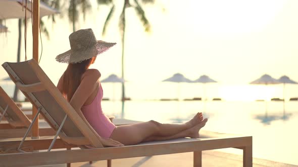 Young asian woman enjoy around outdoor swimming pool for leisure