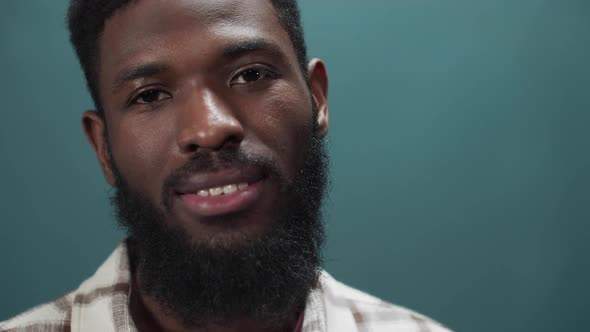 An African Young Man is Standing and Looking at the Camera