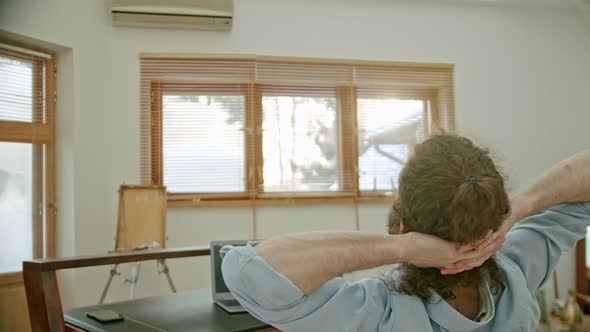 Satisfied Successful Businessman Chilling In Home Office Holding Hands Behind Head