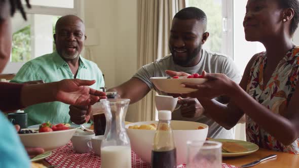 Three generation african american family having breakfast together at home