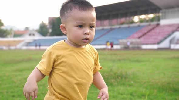 Cute Asian Little Boy Running alt